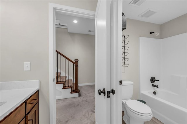 bathroom featuring toilet, vanity, bathtub / shower combination, and recessed lighting
