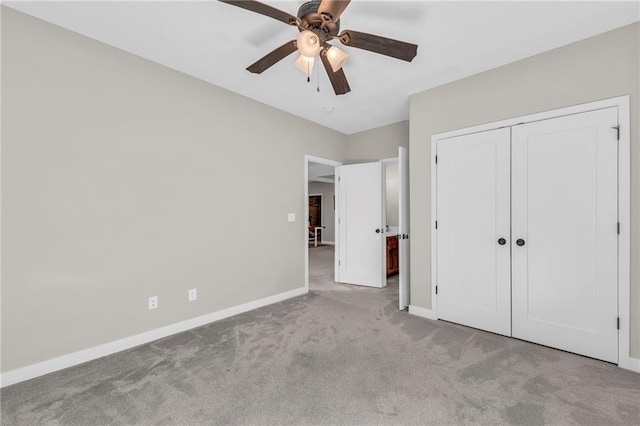 unfurnished bedroom featuring carpet, baseboards, a closet, and ceiling fan