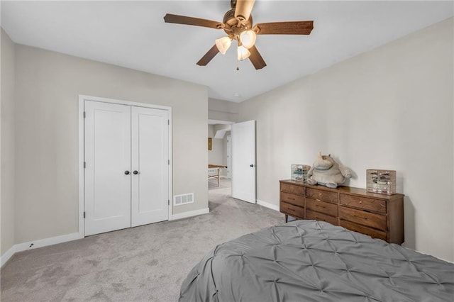 carpeted bedroom with baseboards, a closet, and ceiling fan