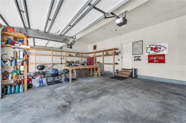 garage with a garage door opener and a workshop area
