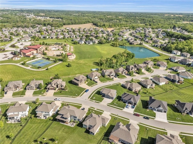 aerial view of property's location featuring a nearby body of water and nearby suburban area