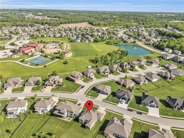 aerial overview of property's location with a nearby body of water and nearby suburban area