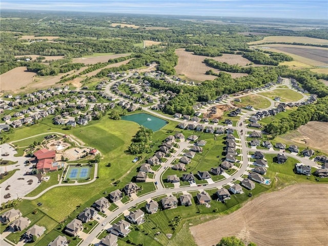 aerial view of property's location with a large body of water and nearby suburban area