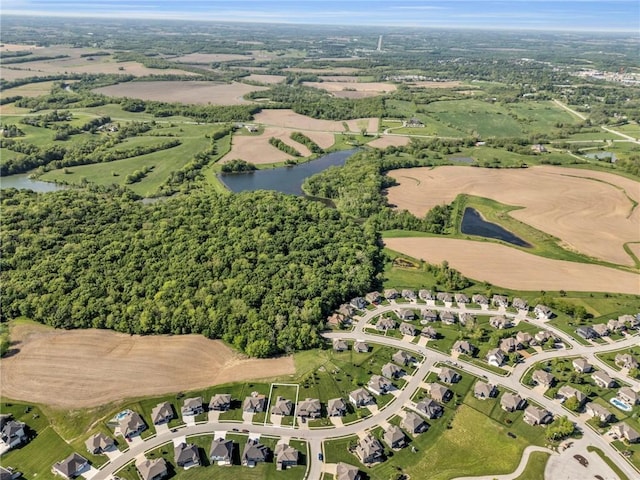 aerial view of property and surrounding area with a large body of water