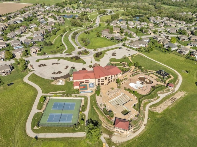 aerial view of property's location featuring a large body of water and nearby suburban area