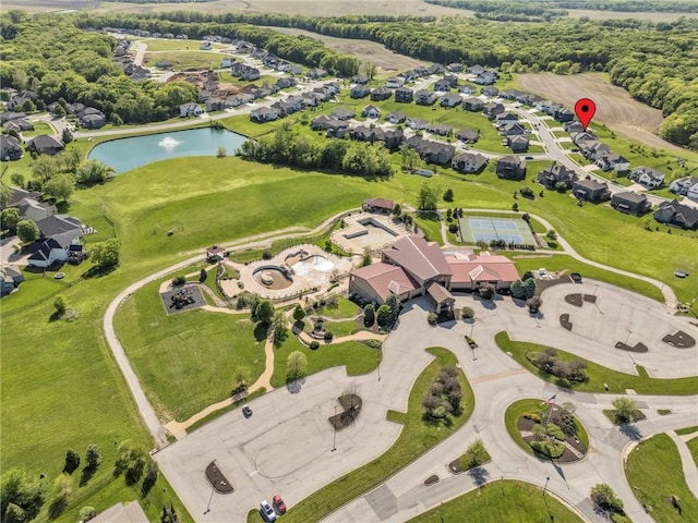 aerial view of property and surrounding area featuring a large body of water and nearby suburban area