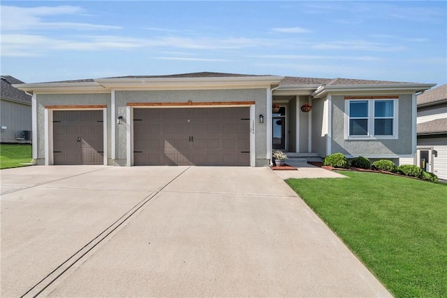 view of front of house featuring a garage, driveway, a front yard, and stucco siding