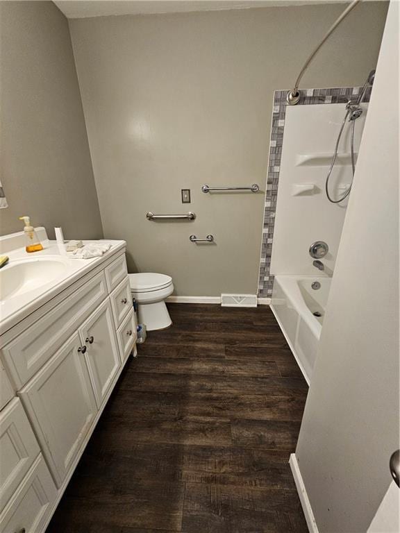 4307 211th St, Belton, MO 64012 - bathroom with wood finished floors, vanity, toilet, tub / shower combination, and baseboards