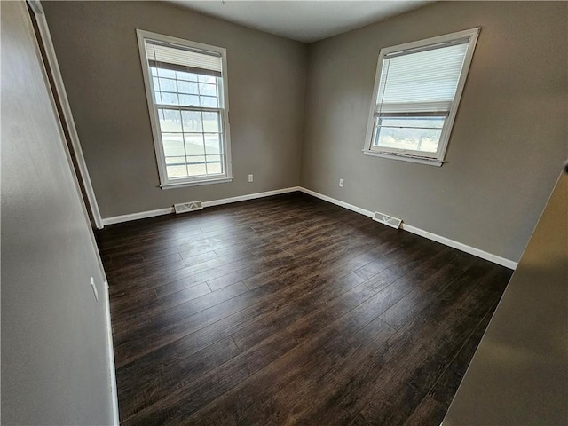 4307 211th St, Belton, MO 64012 - spare room with plenty of natural light, dark wood-style floors, and baseboards