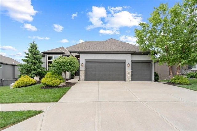 17005 Bradshaw St, Overland Park, KS 66221 - prairie-style home with a garage, concrete driveway, stucco siding, a front yard, and stone siding