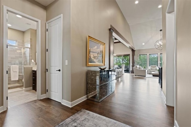 17005 Bradshaw St, Overland Park, KS 66221 - hallway featuring wood finished floors, baseboards, a chandelier, recessed lighting, and high vaulted ceiling