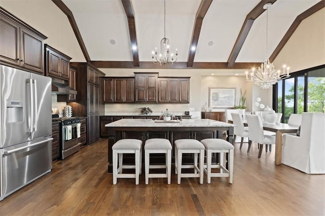 17005 Bradshaw St, Overland Park, KS 66221 - kitchen with a chandelier, appliances with stainless steel finishes, high vaulted ceiling, dark brown cabinetry, and a breakfast bar area
