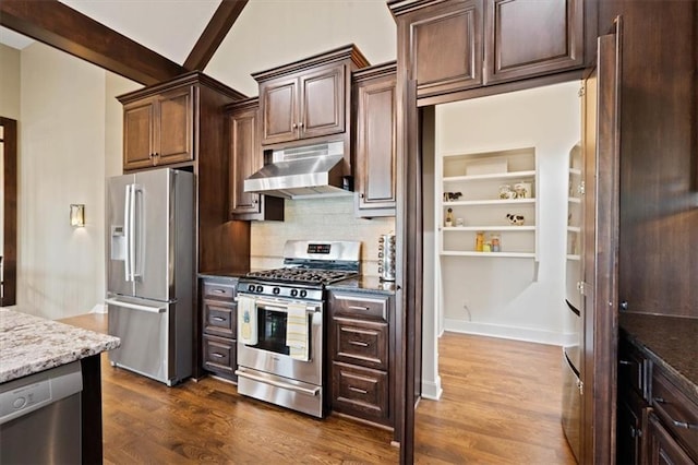 17005 Bradshaw St, Overland Park, KS 66221 - kitchen with appliances with stainless steel finishes, under cabinet range hood, dark wood finished floors, backsplash, and light stone counters
