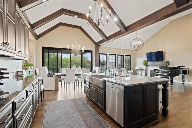 17005 Bradshaw St, Overland Park, KS 66221 - kitchen with a chandelier, appliances with stainless steel finishes, open floor plan, high vaulted ceiling, and a sink