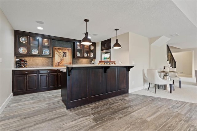17005 Bradshaw St, Overland Park, KS 66221 - bar area featuring light wood finished floors, baseboards, decorative light fixtures, tasteful backsplash, and recessed lighting