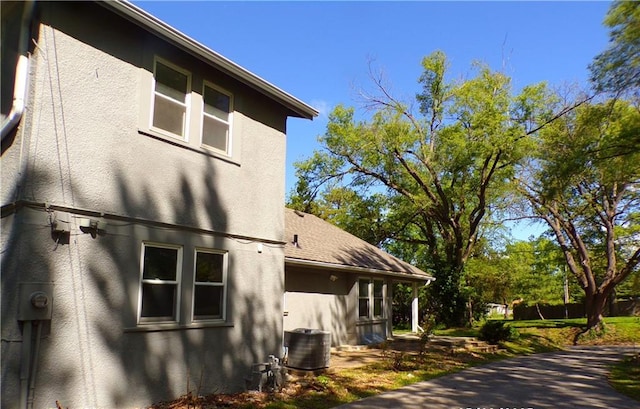 view of home's exterior featuring central air condition unit and stucco siding