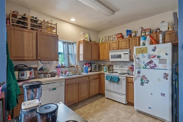425 Thornton St, Leavenworth, KS 66048 - kitchen featuring white appliances, a sink, light countertops, and brown cabinets
