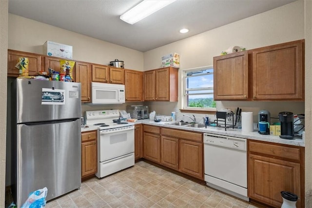 425 Thornton St, Leavenworth, KS 66048 - kitchen featuring white appliances, light countertops, and brown cabinetry