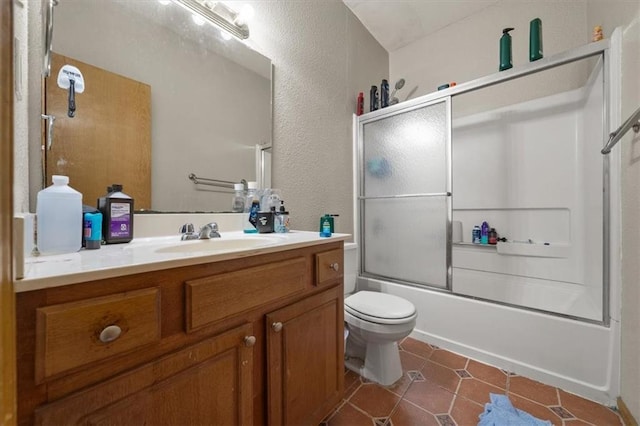 425 Thornton St, Leavenworth, KS 66048 - bathroom with toilet, a textured wall, tile patterned flooring, vanity, and shower / bath combination with glass door