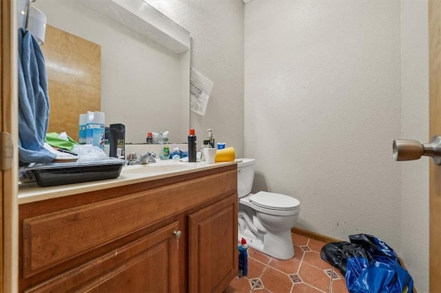 425 Thornton St, Leavenworth, KS 66048 - half bathroom featuring toilet, vanity, a textured wall, and tile patterned floors