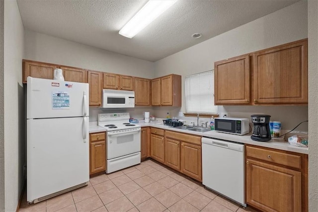425 Thornton St, Leavenworth, KS 66048 - kitchen featuring white appliances, a sink, light countertops, a textured ceiling, and light tile patterned floors