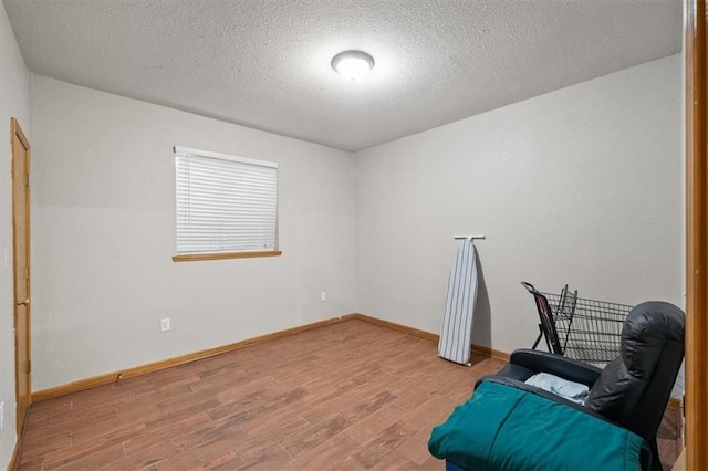 425 Thornton St, Leavenworth, KS 66048 - sitting room featuring wood finished floors, a textured ceiling, and baseboards
