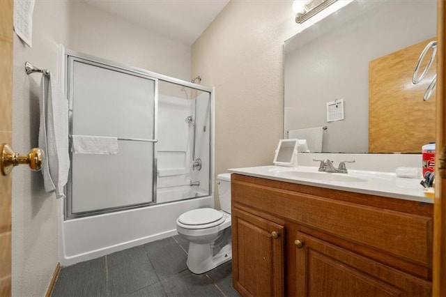 425 Thornton St, Leavenworth, KS 66048 - full bathroom featuring toilet, vanity, shower / bath combination with glass door, and tile patterned flooring