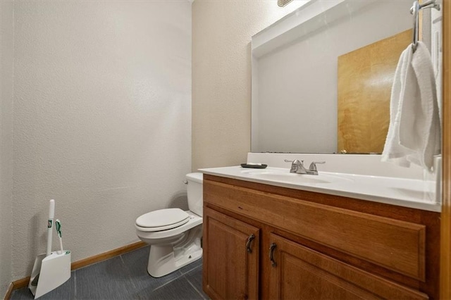 425 Thornton St, Leavenworth, KS 66048 - bathroom with toilet, a textured wall, vanity, and baseboards