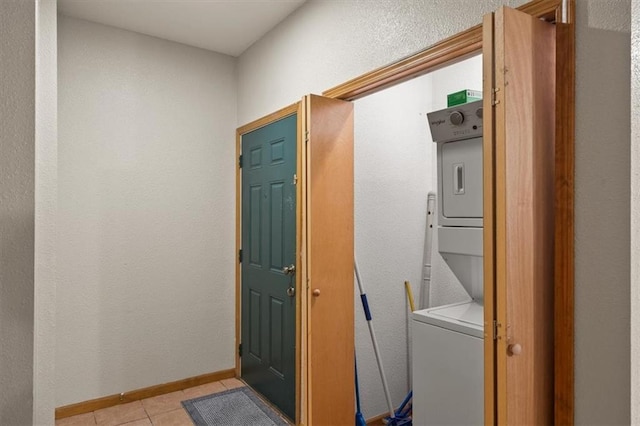 425 Thornton St, Leavenworth, KS 66048 - laundry room featuring stacked washer / drying machine, light tile patterned flooring, and baseboards