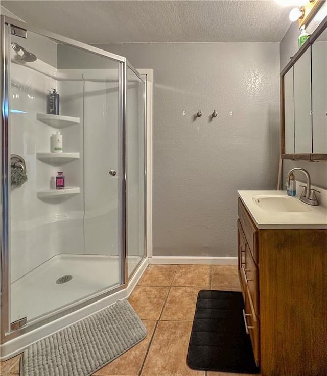 211 Carla St, Excelsior Springs, MO 64024 - full bathroom with vanity, a shower stall, tile patterned floors, a textured ceiling, and a textured wall