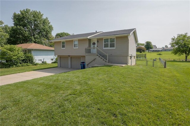 211 Carla St, Excelsior Springs, MO 64024 - view of front facade with an attached garage, a front yard, and driveway