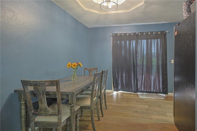 211 Carla St, Excelsior Springs, MO 64024 - dining space featuring wood finished floors, baseboards, and a raised ceiling