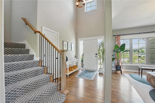 3716 NW 76th St, Kansas City, MO 64151 - entryway featuring stairs, wood finished floors, and a high ceiling