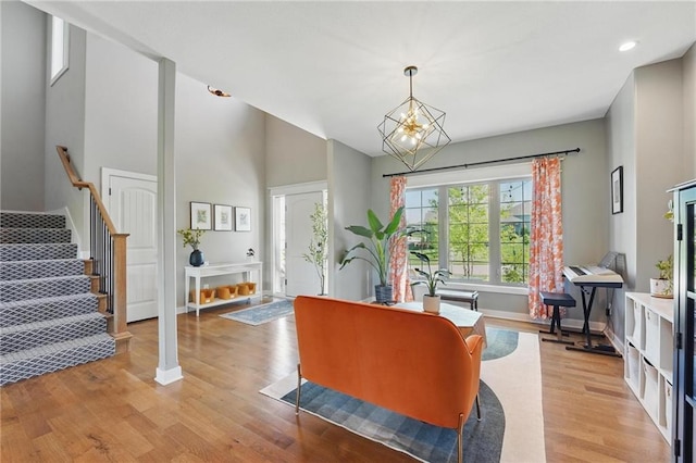3716 NW 76th St, Kansas City, MO 64151 - living area featuring light wood finished floors, stairs, baseboards, a chandelier, and recessed lighting