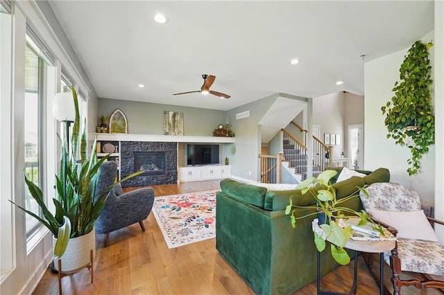3716 NW 76th St, Kansas City, MO 64151 - living room featuring stairway, ceiling fan, wood finished floors, recessed lighting, and a stone fireplace