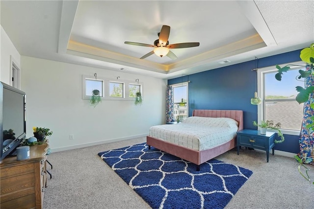 3716 NW 76th St, Kansas City, MO 64151 - carpeted bedroom featuring a raised ceiling, baseboards, and a ceiling fan