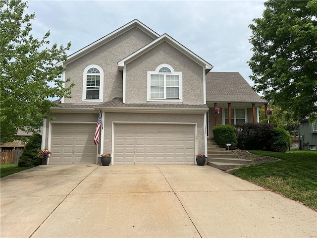 1530 Horseshoe Dr, Raymore, MO 64083 - view of front of house featuring an attached garage, concrete driveway, stucco siding, and a front lawn