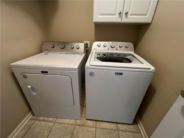 1530 Horseshoe Dr, Raymore, MO 64083 - washroom with cabinet space, washing machine and dryer, baseboards, and light tile patterned floors