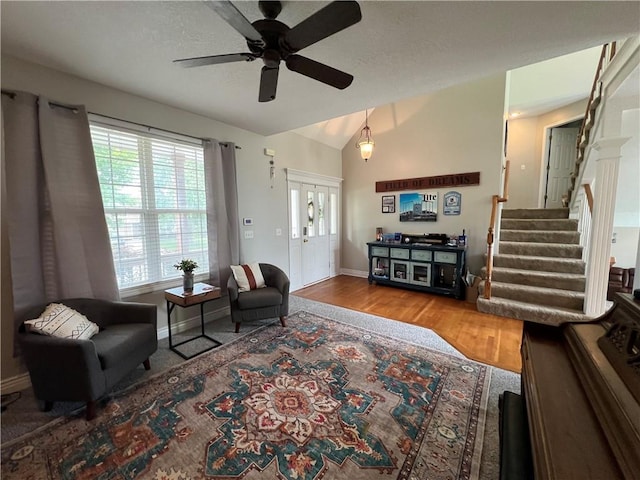 1530 Horseshoe Dr, Raymore, MO 64083 - living area with a ceiling fan, healthy amount of natural light, wood finished floors, baseboards, and vaulted ceiling