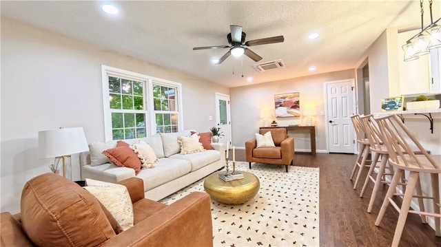 living room featuring dark wood finished floors, ceiling fan, recessed lighting, baseboards, and a textured ceiling