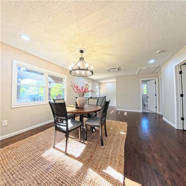 dining room with dark wood-style flooring, a textured ceiling, plenty of natural light, baseboards, and recessed lighting