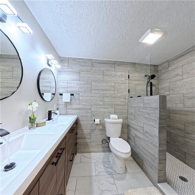 bathroom with toilet, walk in shower, tile walls, marble finish flooring, and double vanity