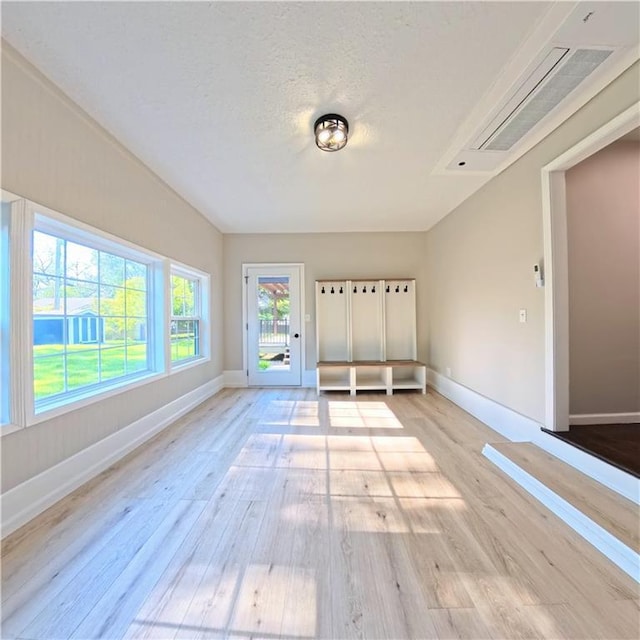 unfurnished bedroom featuring light wood-type flooring and baseboards