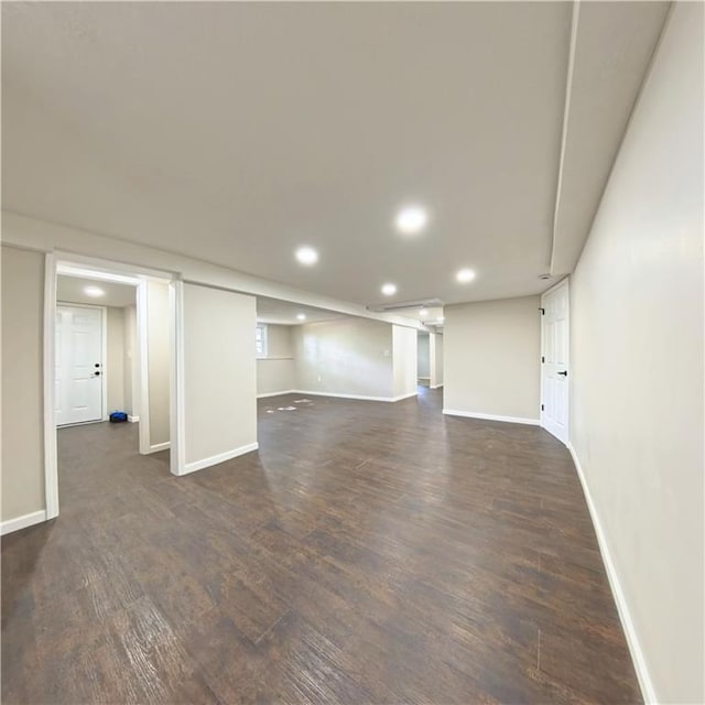 finished below grade area with dark wood finished floors, recessed lighting, and baseboards