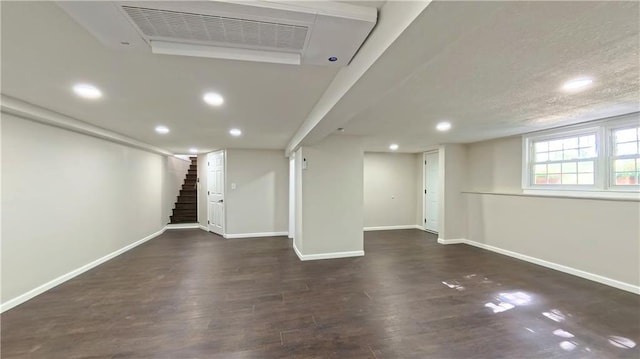 basement with baseboards, stairs, wood finished floors, and recessed lighting