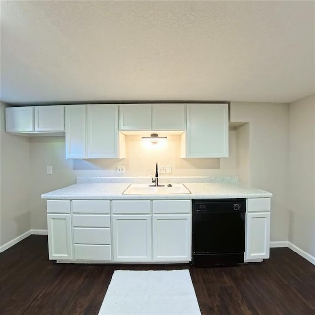 kitchen featuring dishwasher, a sink, baseboards, and white cabinetry