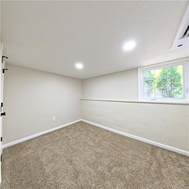 carpeted empty room featuring baseboards and recessed lighting