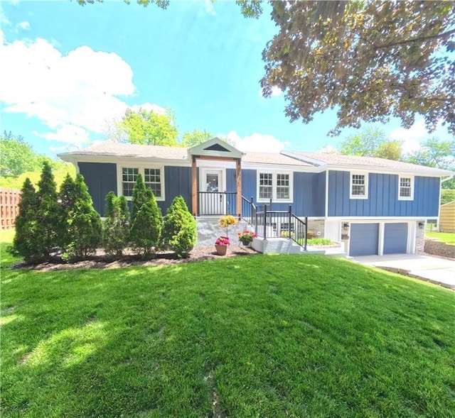 single story home with driveway, a garage, board and batten siding, and a front lawn