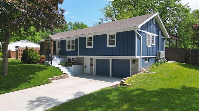 single story home featuring board and batten siding, driveway, an attached garage, and roof with shingles