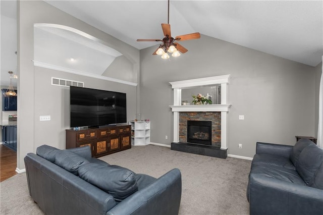 957 NW Dogwood Dr, Grain Valley, MO 64029 - carpeted living room featuring ceiling fan, a stone fireplace, high vaulted ceiling, and baseboards